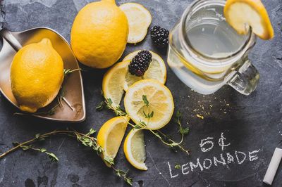 High angle view of lemon by jar on slate