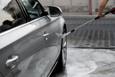 Low section of man cleaning car