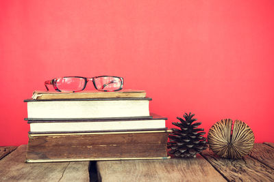 Close-up of books on table against wall