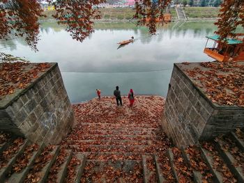 High angle view of people standing by lake