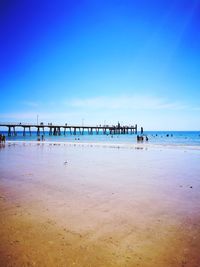 Scenic view of beach against blue sky