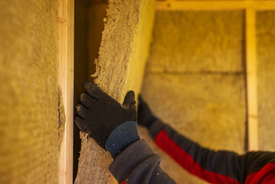 Low section of man standing on wood