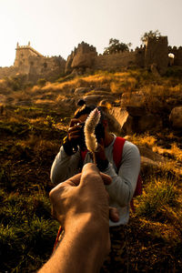 Man photographing friend on location