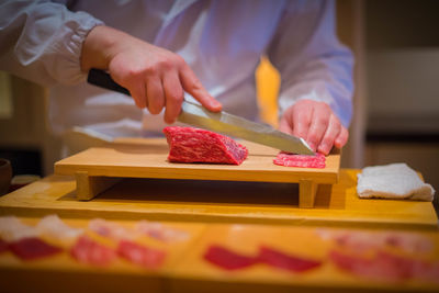 Man preparing food on cutting board