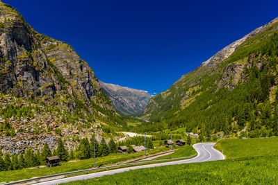 Scenic view of mountains against clear blue sky