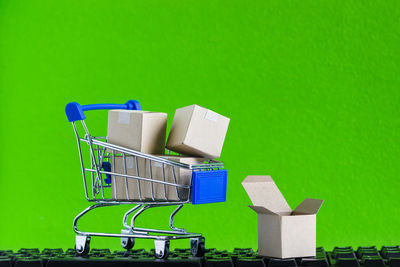 Empty chairs against green background