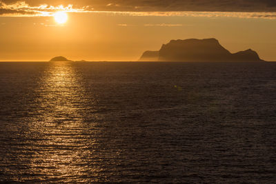 Scenic view of sea against orange sky