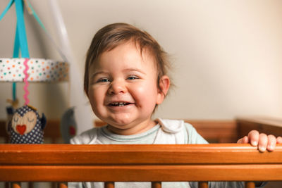 Close-up portrait of cute smiling boy at home