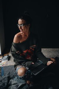 Woman using laptop while siting at home