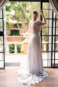 Portrait of young woman standing at home