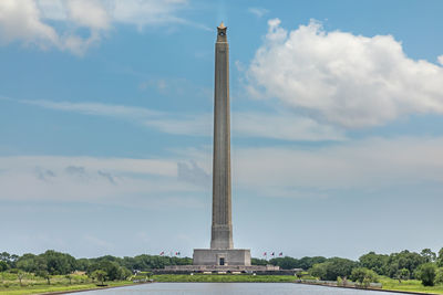 Low angle view of monument against cloudy sky