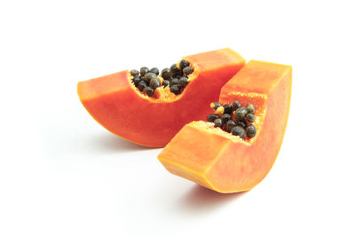 Close-up of orange fruit against white background