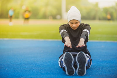 Female athlete exercising on running track