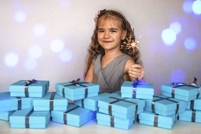 Portrait of young woman holding christmas presents