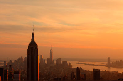 Empire state building against sky during sunset at manhattan