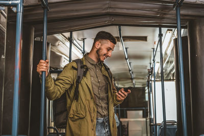 Man reading from mobile phone screen while traveling on metro. wireless internet on public transport