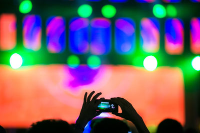 Low section of person using smart phone at music concert