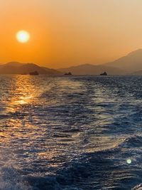 Scenic view of sea against orange sky