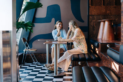 Woman sitting on table