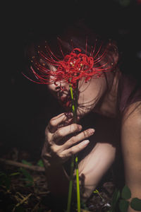 Close-up of woman holding red rose