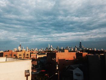 Buildings against cloudy sky