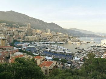 High angle view of houses by sea against sky