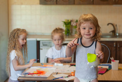 Siblings playing with toys at home