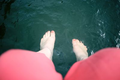 Low section of woman in sea