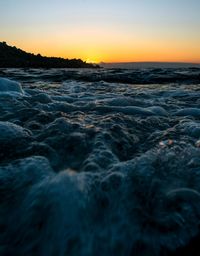 Scenic view of sea against clear sky during sunset