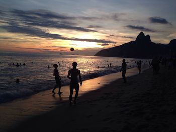 People on beach at sunset