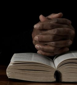 Cropped hand of man holding coins on table