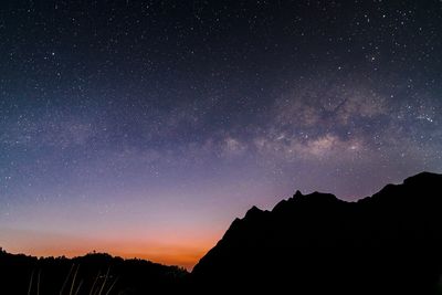 Silhouette mountain against sky at night