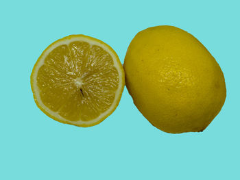 Close-up of lemon slice against clear blue background