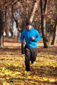 Man jogging at public park during autumn