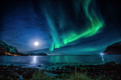 Scenic view of lake against sky at night