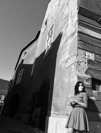 Woman sitting outside building