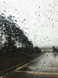 Full frame shot of wet glass window in rainy season