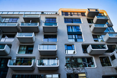 Low angle view of modern german building against clear blue sky