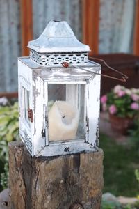 Close-up of old lantern on wood