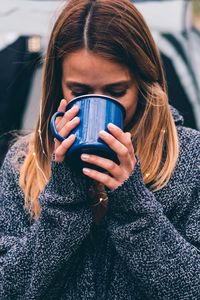 Young woman drinking glasses in winter