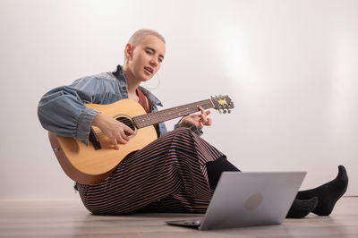 Young woman playing guitar