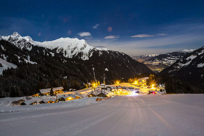 Scenic view of landscape against sky at night during winter