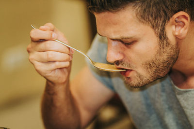 Close-up portrait of man holding ice cream