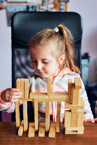 Cute girl playing with block shape at home