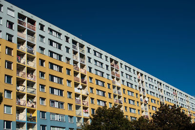 Low angle view of building against clear blue sky