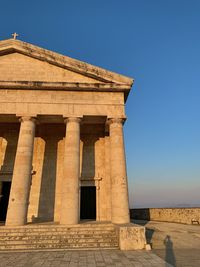 Low angle view of old building against blue sky