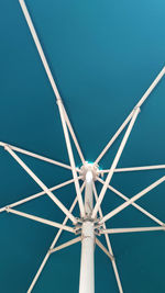 Low angle view of ferris wheel against blue sky