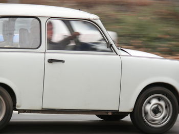 Close-up of car on road