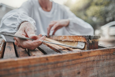 Midsection of man working at workshop