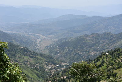 High angle view of valley and mountains against sky